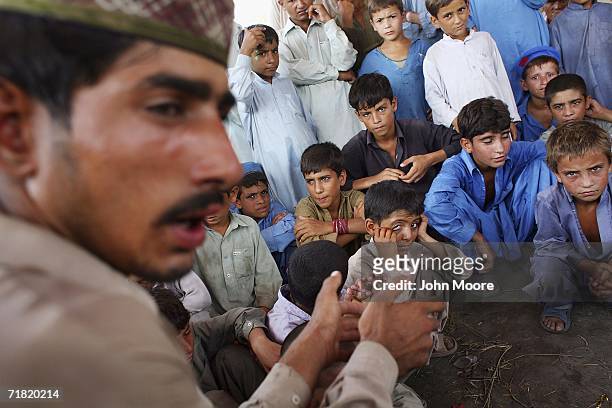 Afghan refugees gather on September 8, 2006 at the Khazana refugee camp on the outskirts of Peshawar, Pakistan. While some of the refugees have...