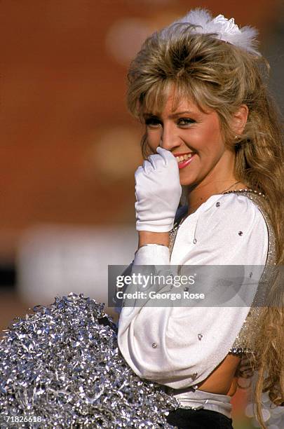 Member of the Raiderette cheerleaders looks on during a game between the Atlanta Falcons and the Los Angeles Raiders at the Los Angeles Memorial...