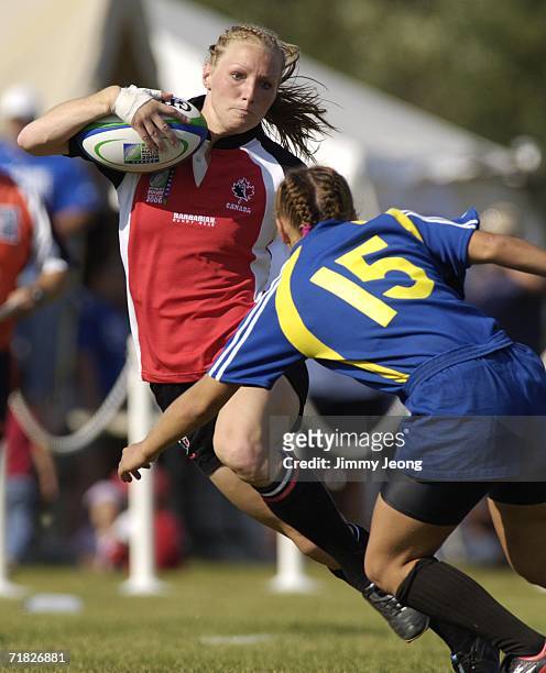 Game MVP Heather Moyse of Canada makes a cut against Svetlana Klyuchnikova of Kazakhstan during day three of the Women's Rugby World Cup 2006 at...