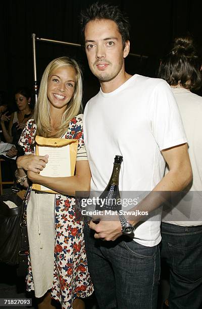 Designer David Neville and Meredith Melling Burke pose backstage at Olympus Fashion Week at the Tunnel club September 8, 2005 in New York City.