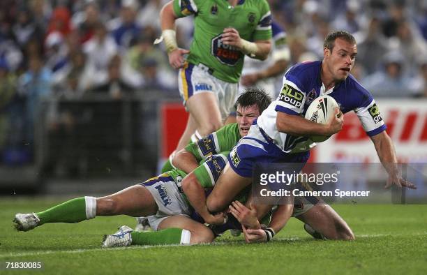 Daniel Holdsworth of the Bulldogs is tackled during the NRL Third Qualifying Final between the Bulldogs and the Canberra Raiders at Telstra Stadium...
