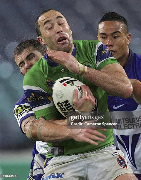 Adam Mogg of the Raiders is tackled during the NRL Third Qualifying Final between the Bulldogs and the Canberra Raiders at Telstra Stadium September...