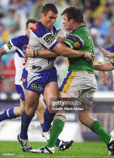 Chris Armit of the Bulldogs is tackled by Kris Kahler of the Raiders during the NRL Third Qualifying Final between the Bulldogs and the Canberra...
