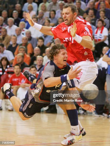 Jonny Jensen of Flensburg tries to score over Sverre Andreas Jakobsson of Gummersbach during the Bundesliga game between SG Flensburg Handewitt and...