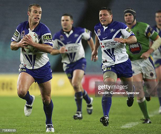 Daniel Holdsworth of the Bulldogs makes a break during the NRL Third Qualifying Final between the Bulldogs and the Canberra Raiders at Telstra...