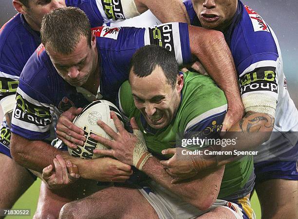 Adam Mogg of the Raiders is tackled during the NRL Third Qualifying Final between the Bulldogs and the Canberra Raiders at Telstra Stadium September...