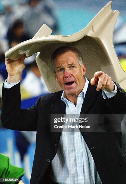 Raiders coach Matthew Elliot shelters from the rain beneath a seat after the NRL Third Qualifying Final between the Bulldogs and the Canberra Raiders...