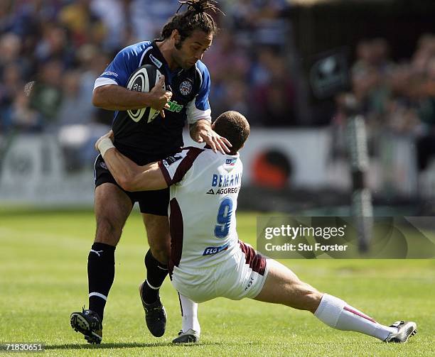 Bath winger Joe Maddock charges past the challenge of Leicester scrum half Scott Bemand during the Guinness Premiership match between Bath and...