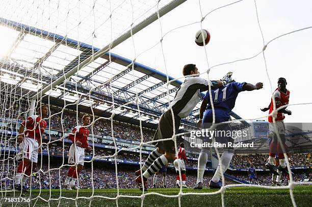 Scott Carson of Charlton Athletic is challenged by Dider Drogba as Ricardo Carvalho of Chelsea scores their second goal during the Barclays...