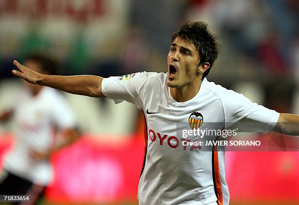 Valencia's David Villa celebrates after scoring the first goal against Atletico de Madrid during their Spanish league football match at Vicente...