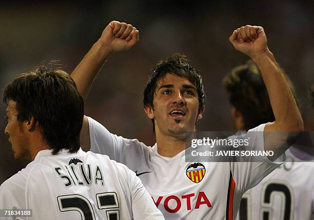 Valencia's David Villa celebrates after scoring the first goal against Atletico de Madrid during their Spanish league football match at Vicente...