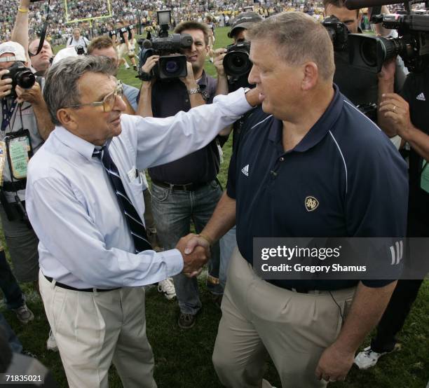 Charlie Weis head coach of the Notre Dame Fighting Irish shakes hands after a 41-17 win Joe Paterno head coach of the Penn State Nittany Lions on...