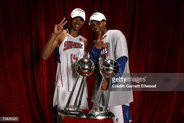 Deanna Nolan and Elaine Powell of the 2006 WNBA Champion Detroit Shock celebrate with the WNBA Championship trophy after winning Game Five of the...