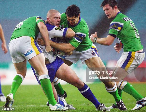 Mark O'Meley of the Bulldogs is stopped by the Raiders defence during the NRL Third Qualifying Final between the Bulldogs and the Canberra Raiders at...