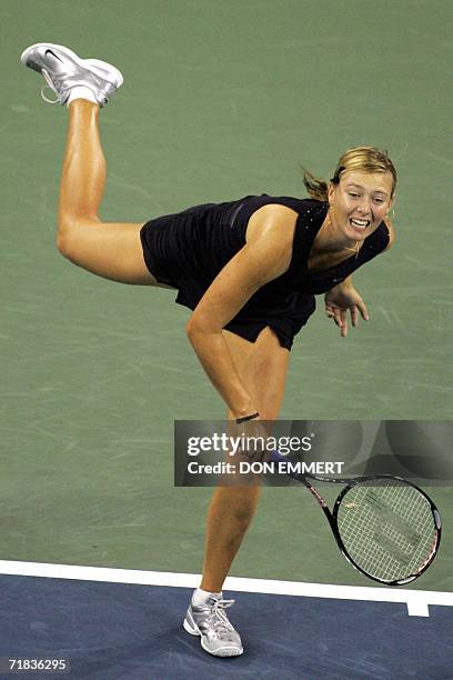 Number three seeded Maria Sharapova of Russia serves the ball to number two seeded Justine Henin-Hardenne of Belgium after the women's finals 09...