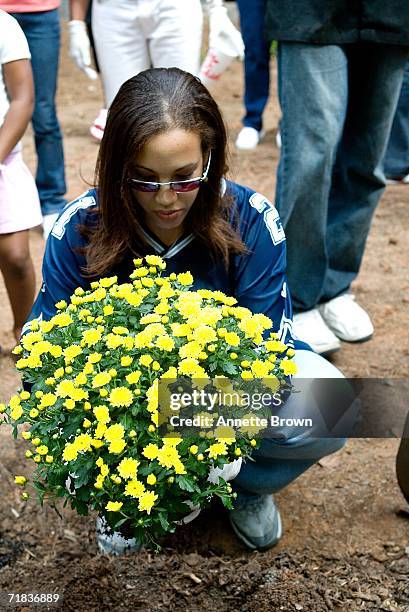 Kalilah Shambry, volunteer, plants her plant in the Peace Garden on September 9, 2006 in Stone Mountain, Georgia.