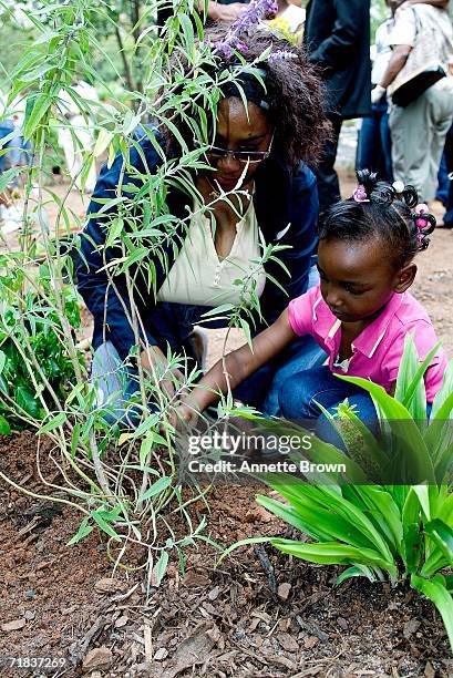Young child and her mother plant their plant in the Peace Garden on September 9, 2006 in Stone Mountain, Georgia.