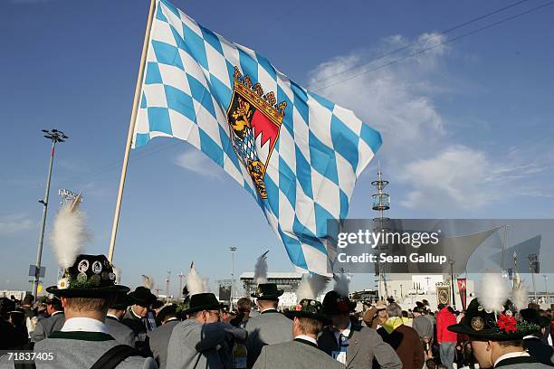 Pilgrims wearing traditional Bavarian folk clothing and waving a Bavarian flag await the arrival of Pope Benedict XVI for an open-air mass September...