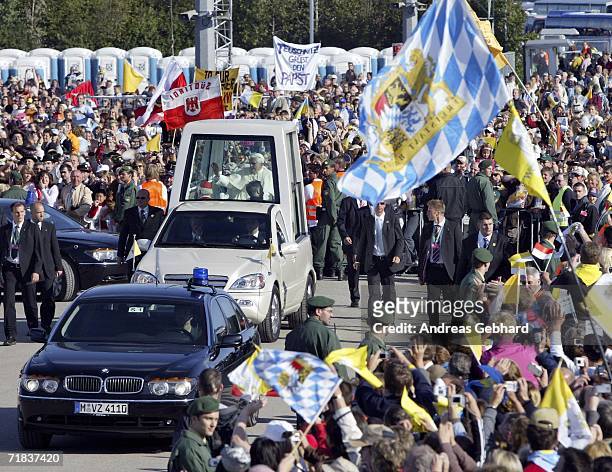 Pope Benedict XVI makes his way through the crowd prior to celebrating the holy mass during his pastoral visit to his native Bavaria on the trade...