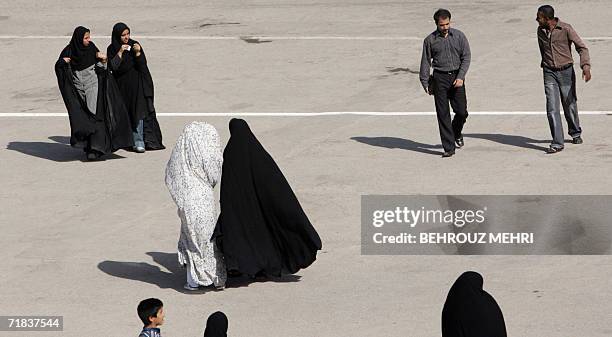 Iranians walk in the courtyard of the Jamkaran mosque outside the religious city of Qom 120 kms south of Tehran, 08 September 2006. Hundreds of...