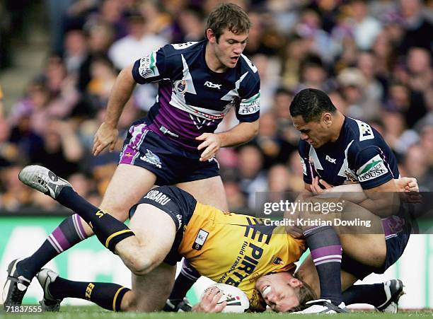 Glenn Morrison of the Eels is tackled by David Kidwell of the Storm during the NRL Fourth Qualifying Final between the Melbourne Storm and the...
