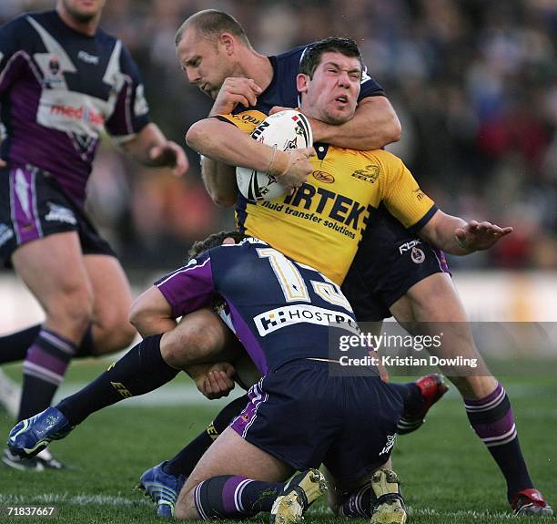 Brett Delaney of the Eels is tackled by Scott Hill and Dallas Johnson of the Storm during the NRL Fourth Qualifying Final between the Melbourne Storm...