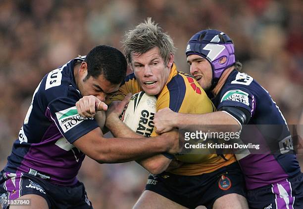Glenn Morrison of the Eels is tackled by Brett White and Nathan Friend of the Storm during the NRL Fourth Qualifying Final between theMelbourne Storm...