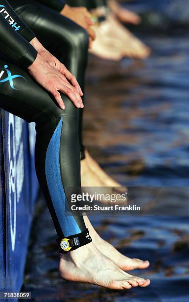 Swimmers sit by the water at the start of the Age Group Olympic distance competition at the Hamburg City Man Triathlon on September 10, 2006 in...