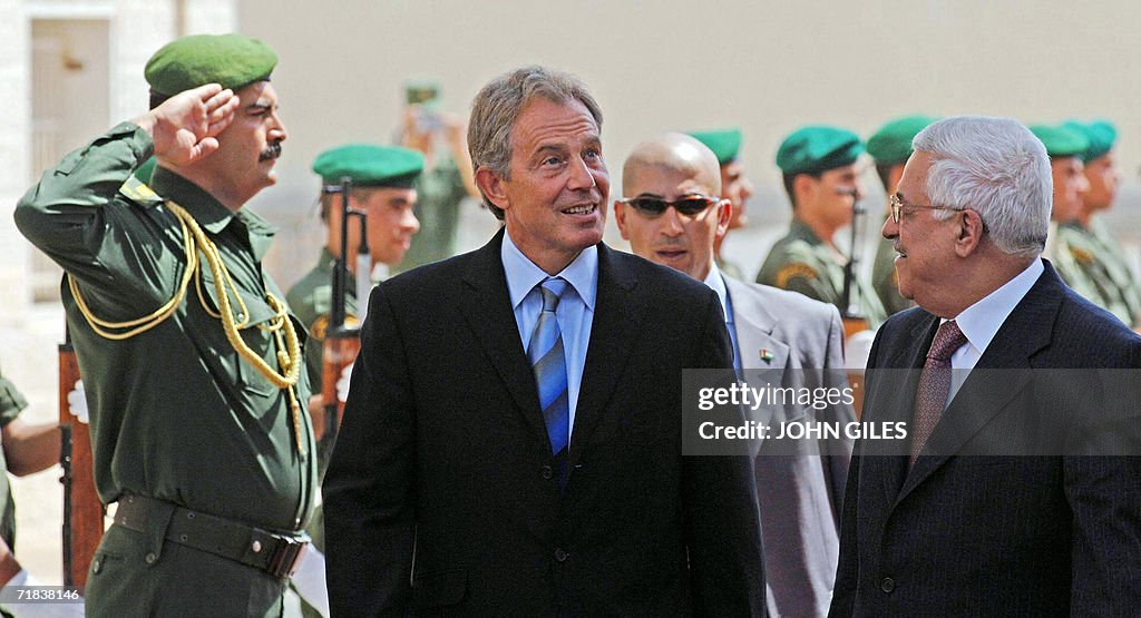 British Prime Minister Tony Blair walks past the honor guard along
