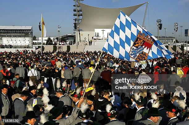 Believers wave a Bavarian flag as they attend a mass led by Pope Benedict XVI during his visit to his native Bavaria region 10 September 2006 in...