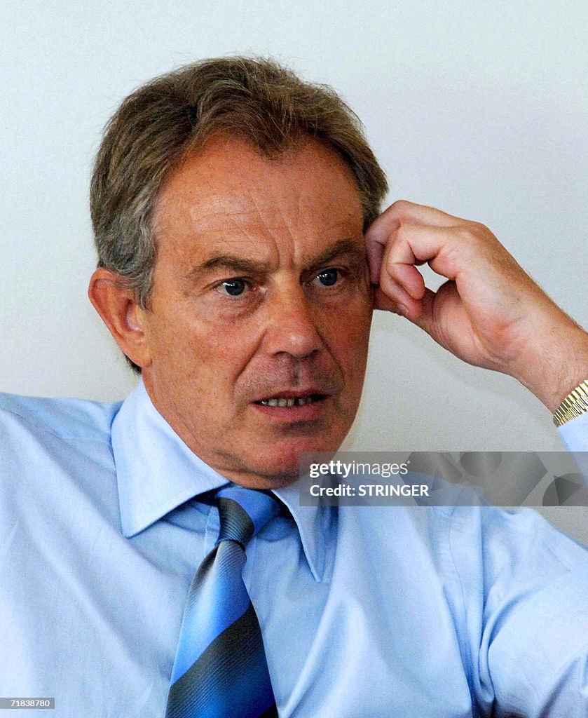 British Prime Minister Tony Blair talks with Palestinian officials at