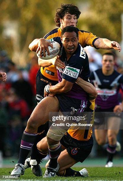 Antonio Kaufusi of the Storm is tackled by Nathan Hindmarsh of the Eels during the NRL Fourth Qualifying Final between the Melbourne Storm and the...