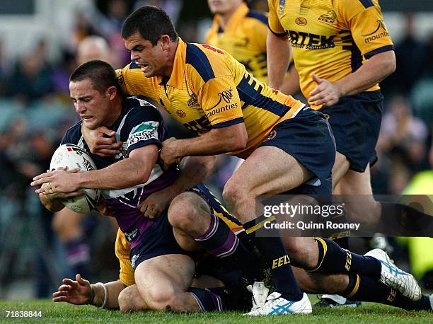 Cooper Cronk of the Storm is tackled by Daniel Wagon of the Eels during the NRL Fourth Qualifying Final between the Melbourne Storm and the...