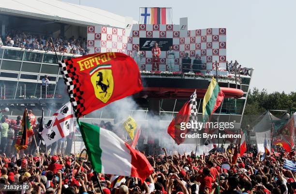 Italian fans celebrate Michael Schumacher's win in the Italian Formula One Grand Prix at the Autodromo Nazionale Monza on September 10, 2006 in...