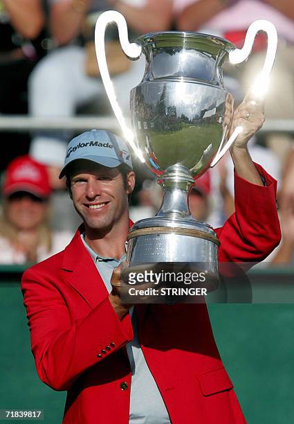 Crans-sur-Sierre, SWITZERLAND: Welsh Bradley Dredge holds the trophy after winning the EPGA Golf European Master, in Crans-Montana 10 September 2006....