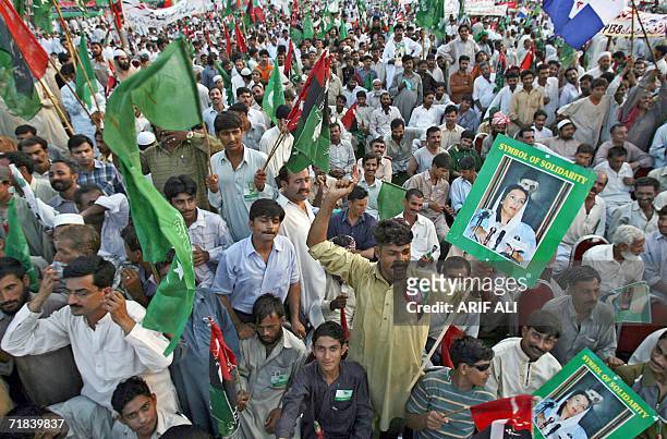 Activists of the Alliance for Restoration of Democracy hold party flags as they shout anti-government slogans during a rally in Lahore, 10 September...