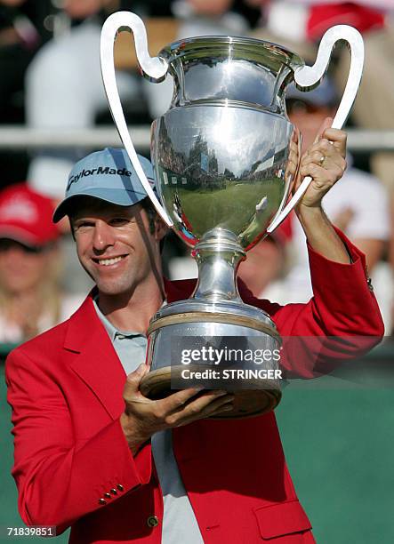 Crans-sur-Sierre, SWITZERLAND: Welsh Bradley Dredge holds the trophy after winning the EPGA Golf European Master, in Crans-Montana 10 September 2006....