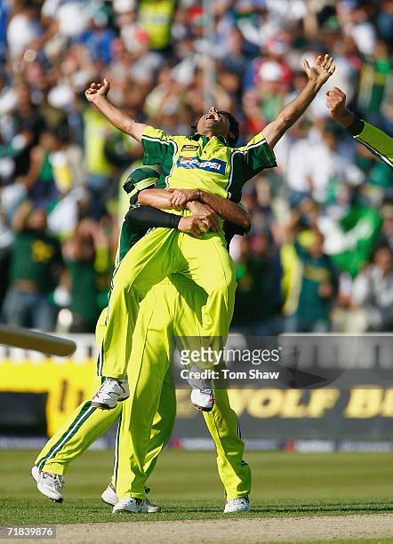 Abdul Razzaq of Pakistan is lefted up by teammates after taking the wicket of Paul Collingwood of England during the 5th NatWest Series One Day...