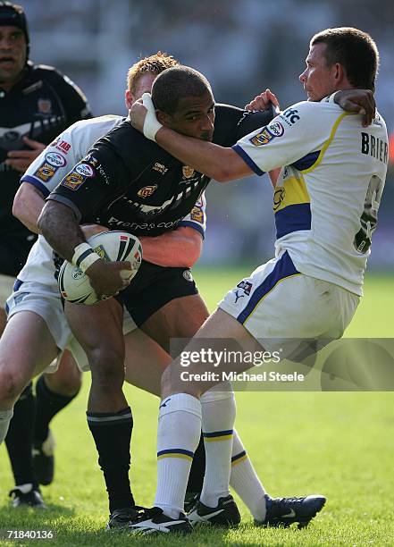 Gareth Raynor of Hull is held up by Lee Briers and Chris Riley of Warrington during the Engage Super League match between Warrington Wolves and Hull...