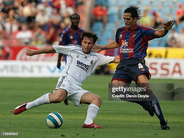 Antonio Cassano of Real Madrid crosses the ball beside Camacho of Levante during the Primera Liga match between Levante and Real Madrid at the Ciutat...