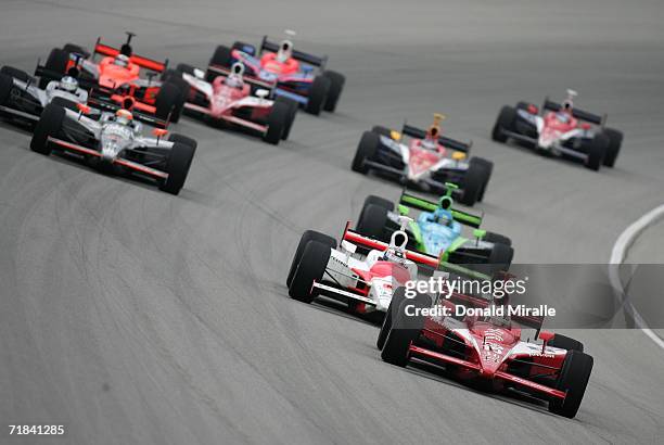 Dan Wheldon, driver of the Target Chip Ganassi Honda Dallara, leads the pack and Sam Hornish Jr., driver of the Marlboro Team Penske Honda Dallara,...