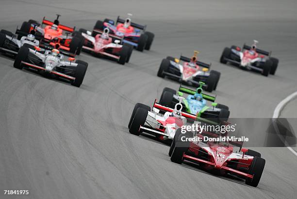 Dan Wheldon, driver of the Target Chip Ganassi Honda Dallara, leads the pack and Sam Hornish Jr., driver of the Marlboro Team Penske Honda Dallara,...