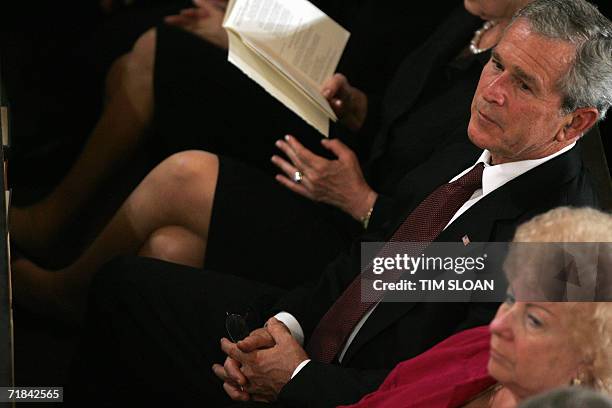 New York, UNITED STATES: US President George W. Bush and First Lady Laura Bush sing a hymn during a Service of Prayer and Rememberance 10 September...