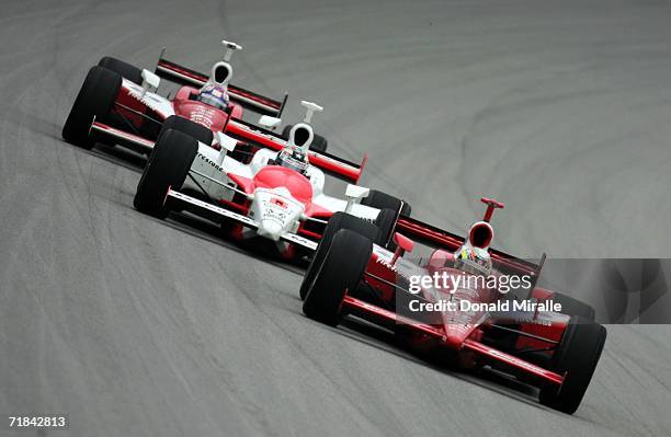 Dan Wheldon, driver of the Target Chip Ganassi Dallara Honda, leads Sam Hornish Jr., driver of the Marlboro Team Penske Honda Dallara, and his...