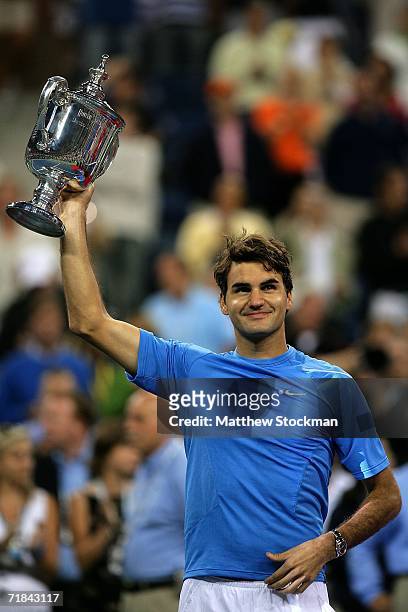 Roger Federer of Switzerland holds up the championship trophy after defeating Andy Roddick in the men's final of the U.S. Open at the USTA Billie...