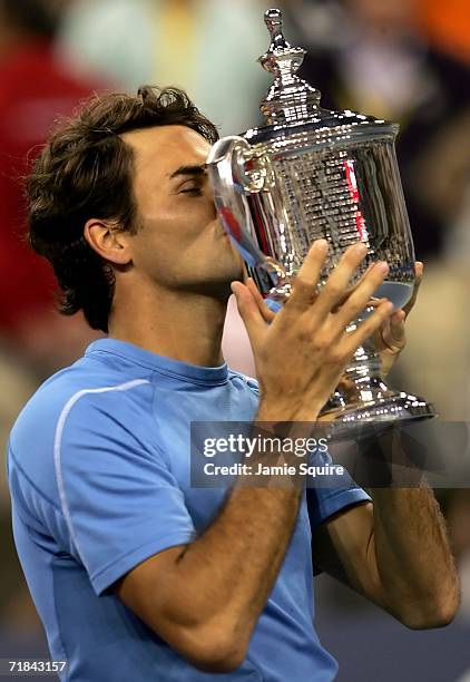 Roger Federer of Switzerland kisses the championship trophy after defeating Andy Roddick in the men's final of the U.S. Open at the USTA Billie Jean...