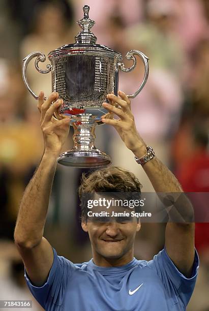 Roger Federer of Switzerland holds up the championship trophy after defeating Andy Roddick in the men's final of the U.S. Open at the USTA Billie...