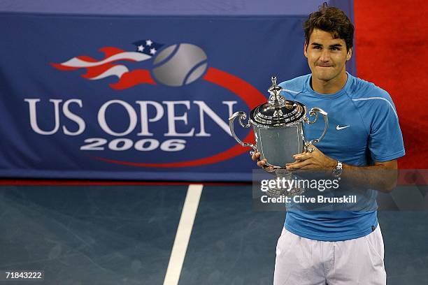 Roger Federer of Switzerland poses with the championship trophy after defeating Andy Roddick in the men's final of the U.S. Open at the USTA Billie...