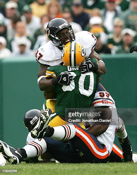 Ahman Green of the Green Bay Packers is stopped by Mark Anderson and Tank Johnson of the Chicago Bears on September 10, 2006 at Lambeau Field in...