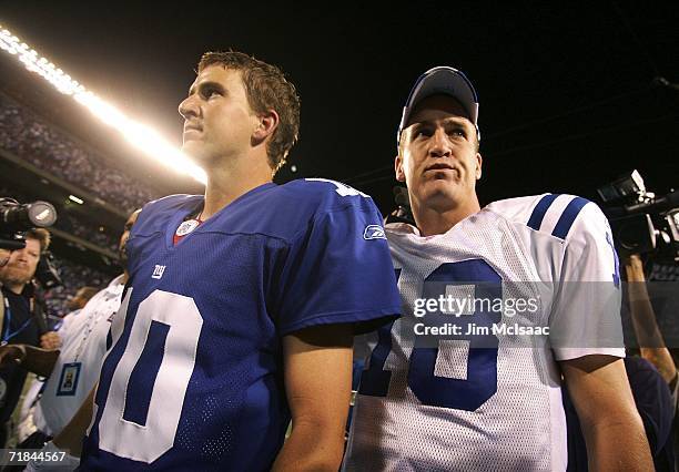 Quarterback Eli Manning of the New York Giants congratulates his brother quarterback Peyton Manning of the Indianapolis Colts on his 26-21 victory on...